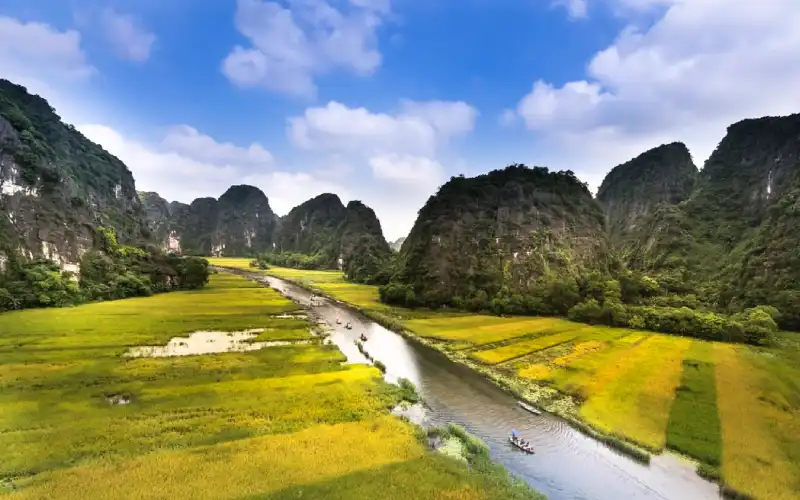 Visitors enjoying a boat ride through Tam Coc