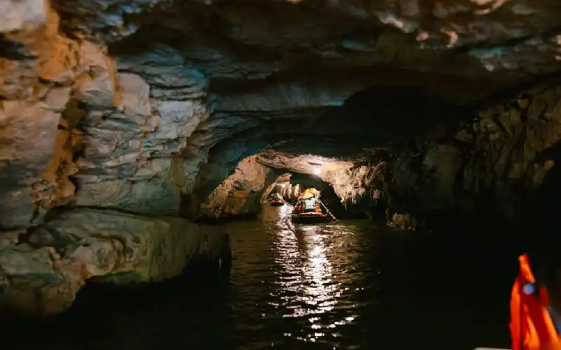 Boat entering a cave in Trang An Landscape Complex
