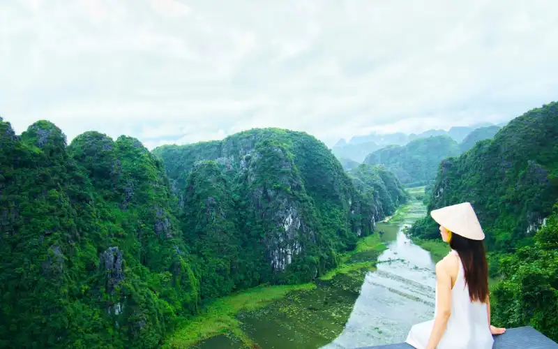 Towering limestone karst mountains and emerald waters in Trang An UNESCO heritage site