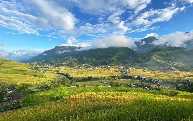 Wide landscape showing rice terraces and mountain scenery.