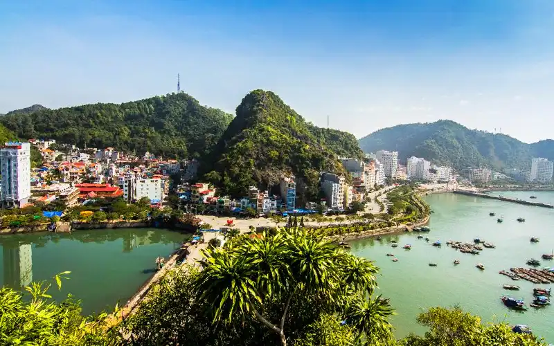cat-ba-town-arrival-guide Cat Ba Town waterfront and limestone mountains in Vietnam