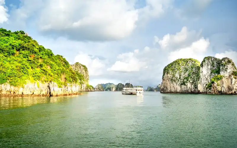 Overnight cruise sailing among limestone islands in Ha Long Bay Vietnam