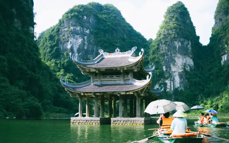 Trang An boat tour among limestone mountains in Ninh Binh Vietnam